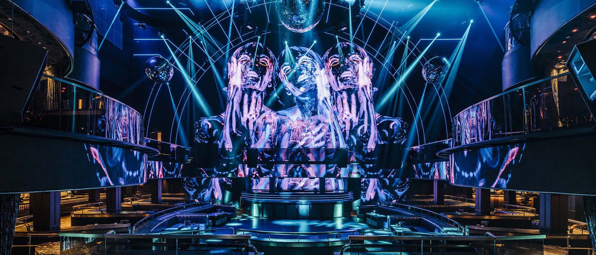 Interior of MARQUEE Singapore, with blue lighting, a central stage and surrounding balconies