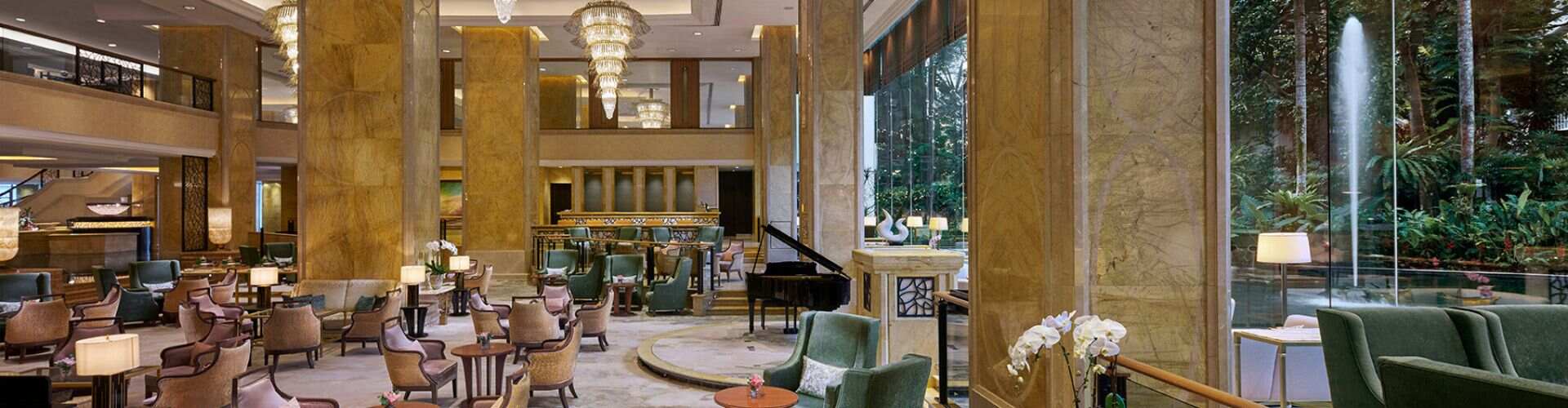 The Lobby Lounge at Shangri-La Kuala Lumpur, with chandeliers, lounge seating and a water garden
