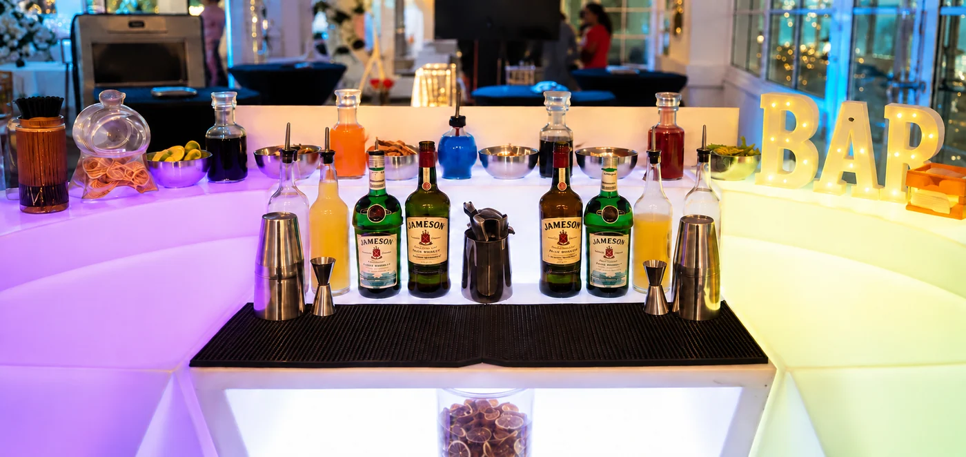 A complete illuminated Vibe N Pour mobile bar prepared for an event.