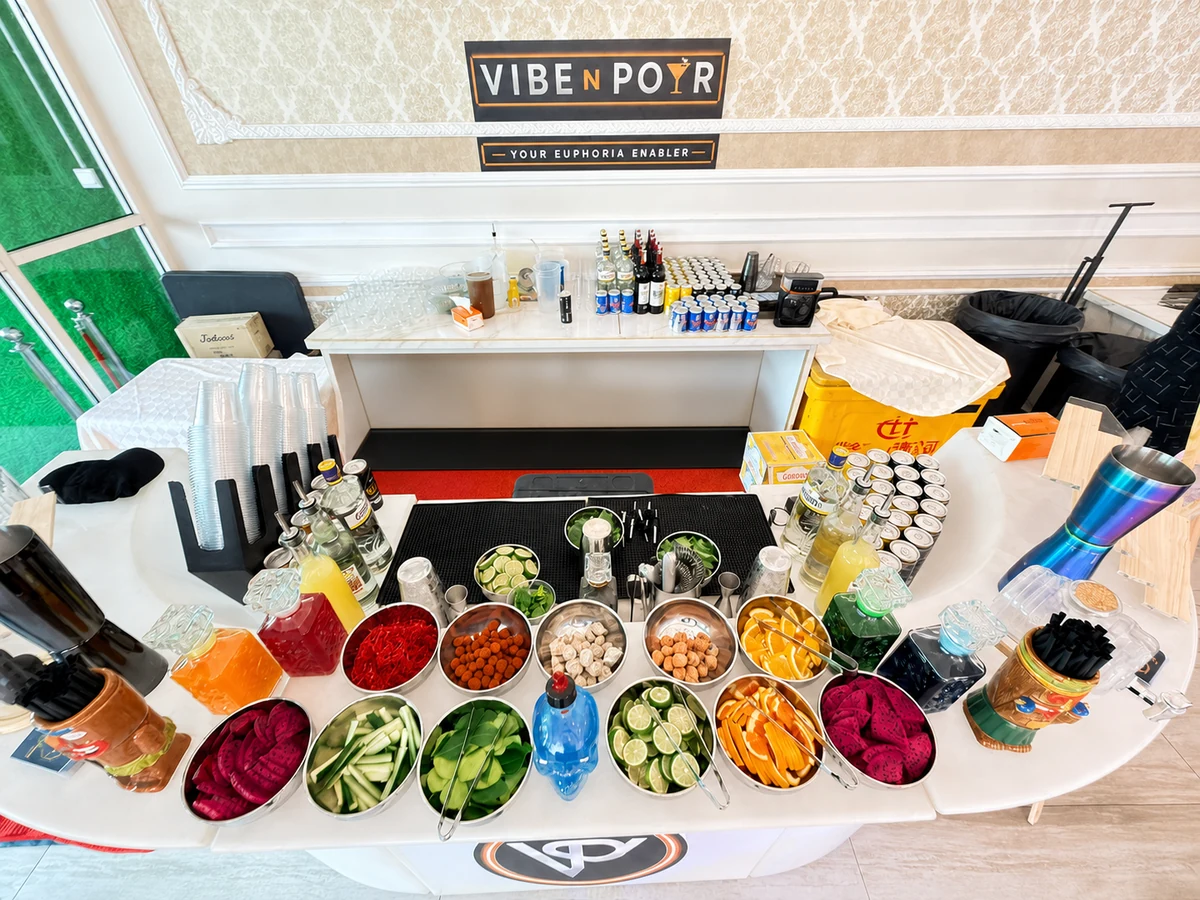 An overhead view of the Vibe N Pour bar setup with fresh ingredients and drink supplies.